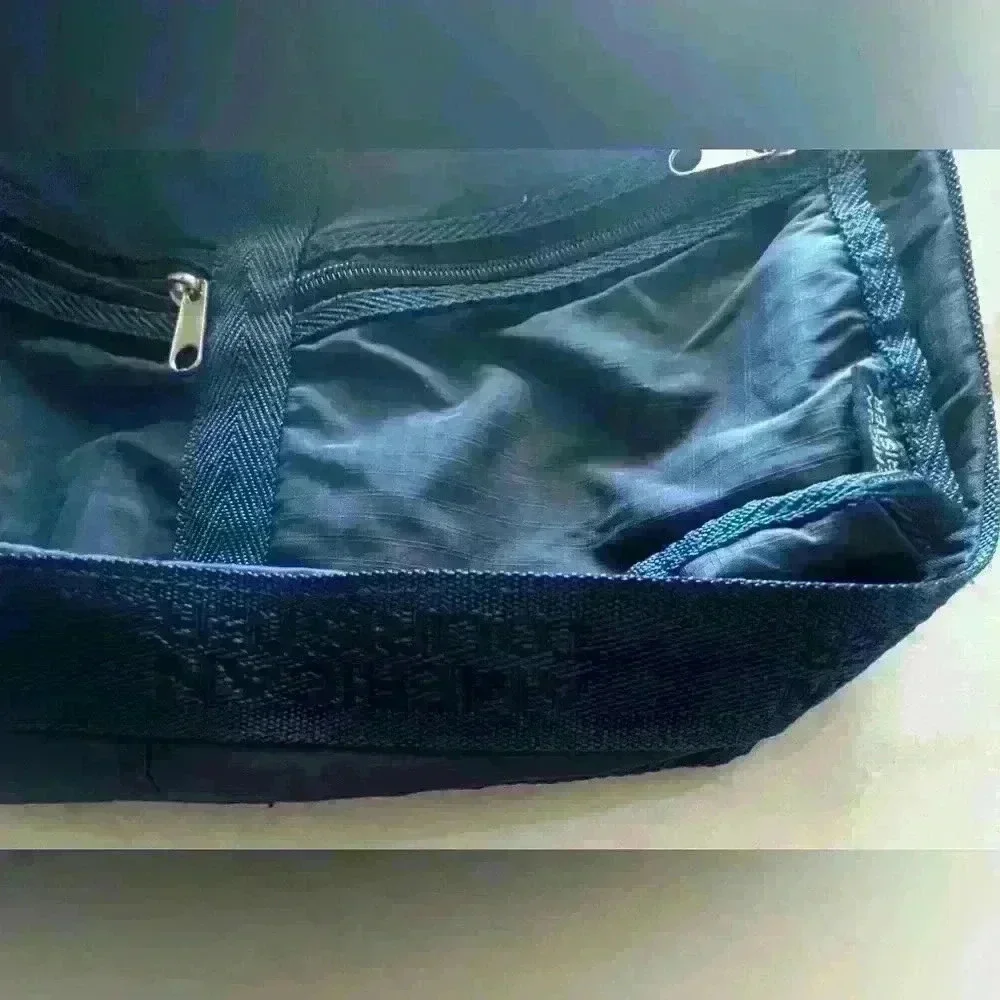 American Tourister dark blue nylon adjustable strap crossbody bag.